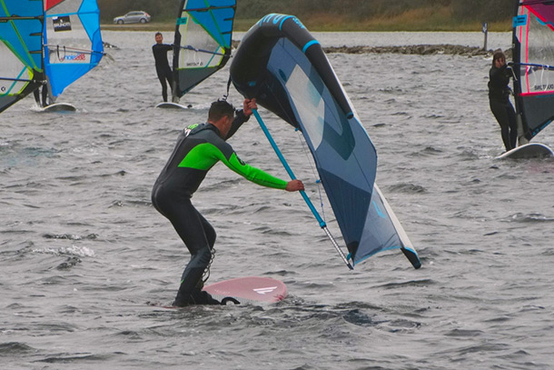 Stand on the board and hold the wing lower.